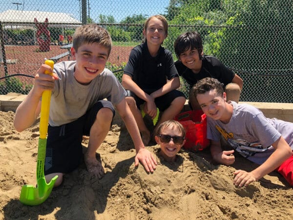dude-camp kids playing in the sand